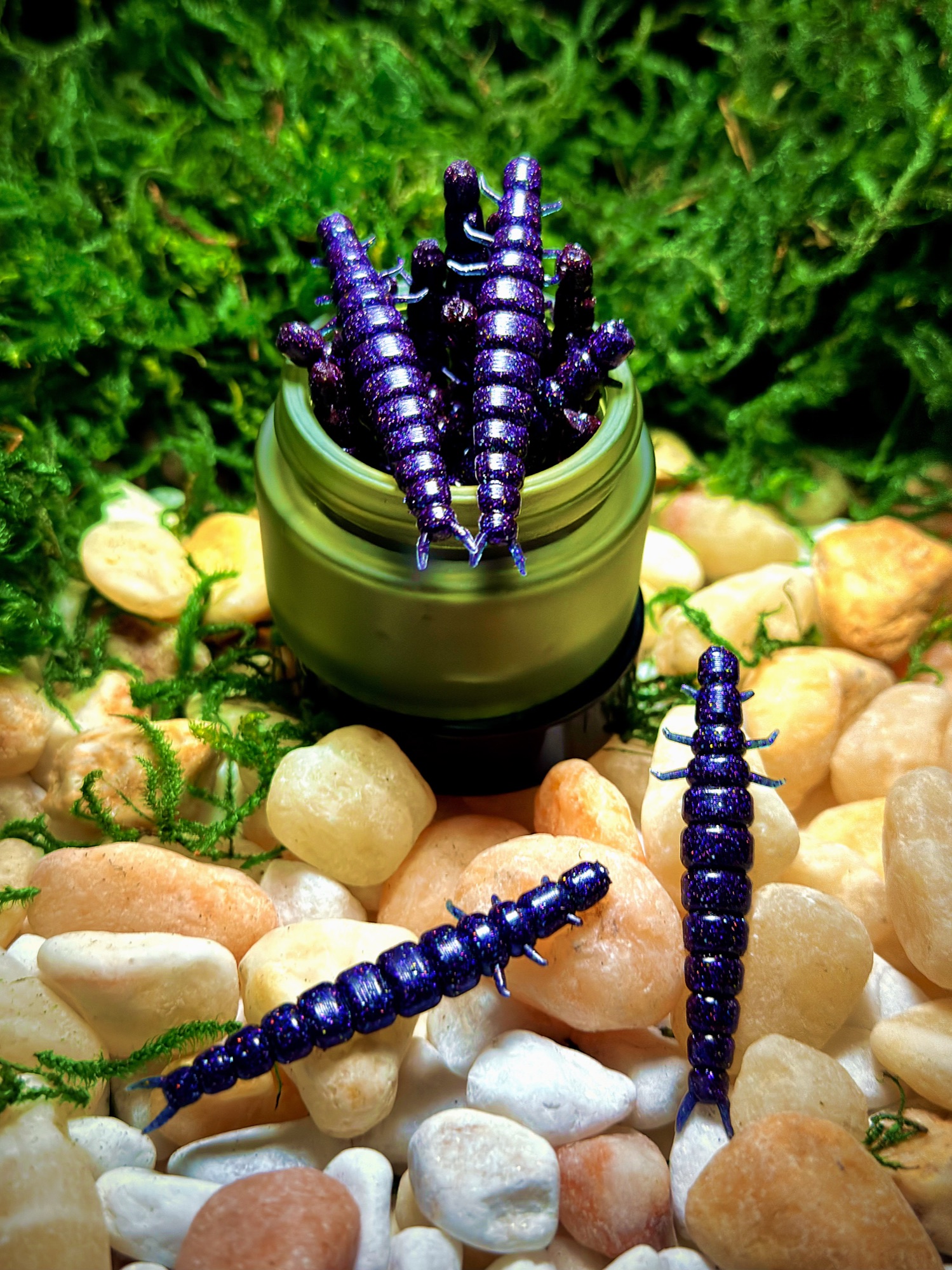 Purple glitter 2-inch hellgrammite soft baits in a green Homewrecker jar